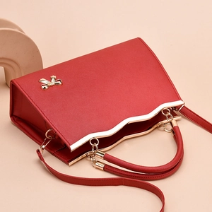 Elegant red bridal handbag with bow decoration, gold hardware, and metal handles