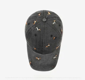 Top view of washed cotton baseball cap with colorful dog embroidery and vintage texture