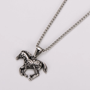 Macro detail of vintage stainless steel horse pendant with intricate carved textures