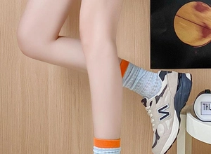 Detail of mesh cotton mid-calf socks in grey with blue patterns and orange cuffs