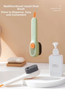 Close-up of liquid-dispensing shoe brush with soft bristles and hanging loop