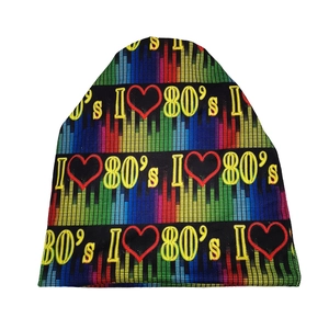 Close-up of retro I Love 80s knit beanie with colorful equalizer stripes and yellow font