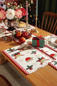 Close-up of Christmas table mat with red snowflake patterns and classic plaid edge decor