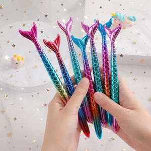 Detailed close-up of gradient mermaid tail pens with shiny scales and colorful finishes