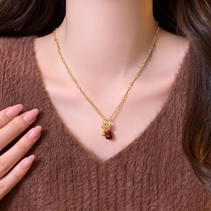 18k gold plated necklace featuring double red gourd pendants worn on a sweater