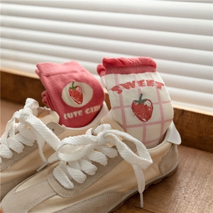 Detail of pink strawberry cotton socks with Cute Girl and Sweet text in beige sneakers