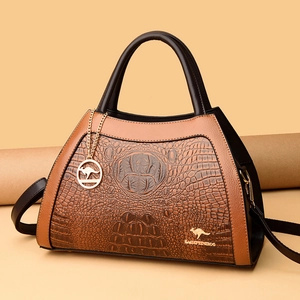 Brown and black crocodile pattern crossbody bag with golden kangaroo pendant and handles
