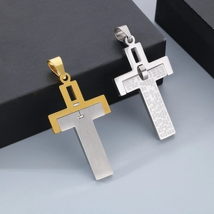 Detailed macro of stainless steel cross pendants with engraved religious scripture text