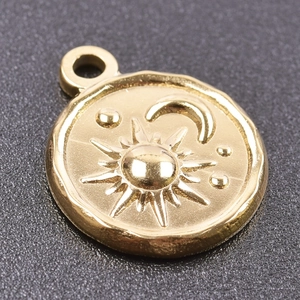 Close-up of golden sun and crescent moon relief charm for DIY jewelry making