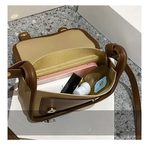 Detail view of contrast color shoulder bag interior capacity and storage compartments