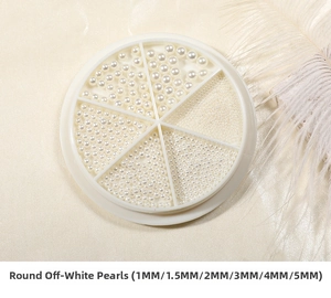 Top view of white pearl nail art charms in a 6-grid container on satin background