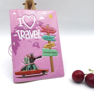 Detail of pink faux leather passport cover with embossed world map and city signs