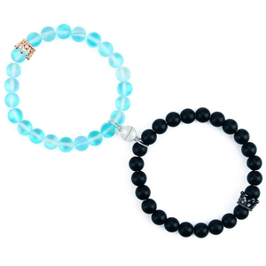 Detail of magnetic couple bracelets with 8mm matte beads and crown charms
