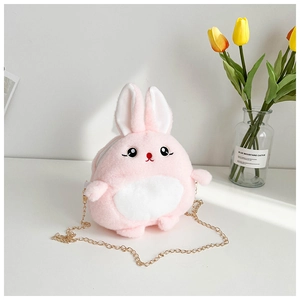 Detailed view of pink plush bunny crossbody bag with golden chain strap on white desk