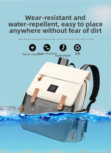 Close-up of three-color waterproof diaper bag partially submerged to show water resistance