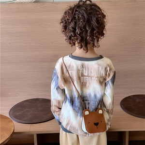 Cute brown bear cross-body bag for kids with tie-dye hoodie on a young child model