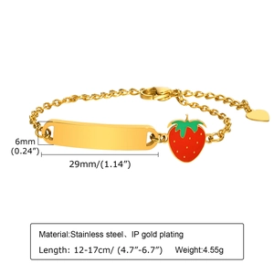 Detail of adjustable gold stainless steel bracelet with strawberry charm and blank bar
