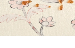 Close-up of waterproof beige vintage floral rug fabric with water droplets