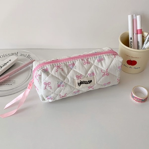 Detail of quilted stationery bag with pink bows and purple floral patterns