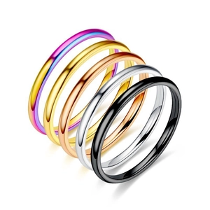 Set of five minimalist stackable titanium steel rings in various metallic finishes