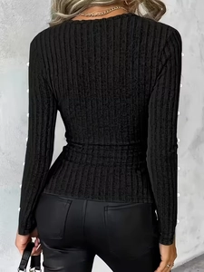 Chic black slim fit long sleeve top with textured knit fabric and ribbed finish