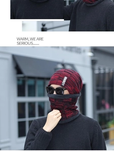 Detail of red and black knit hat with thick grey fleece lining for winter warmth