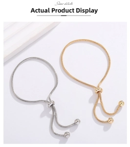Detail view of adjustable snake bone chain bracelets in gold and silver finish with slide clasp