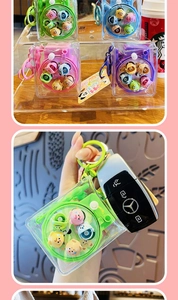 Transparent camera-shaped mini storage bag keychain with cartoon figures in four colors