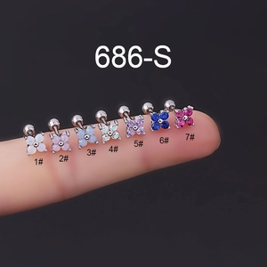 Macro shot of colorful zircon flower earrings on fingers showing screw back closure