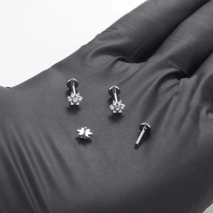 F136 titanium labret stud with a silver flower design and white cubic zirconia crystals
