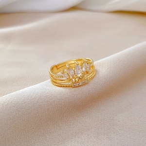 Detailed close-up of golden crown ring with LOVE engraving and pavé set zircons