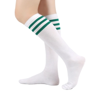 Detail of white knee-high socks with green three-stripe ribbing on high-stretch knit fabric