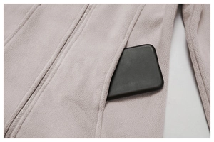 Detail of fleece jacket side pocket showing ample storage capacity for a smartphone