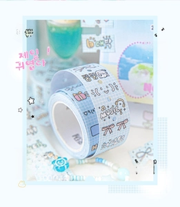 Close-up of blue plaid washi tape featuring cute bows and musical note illustrations