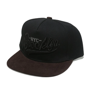 Detail of Brooklyn embroidery on a two-tone baseball cap with brown suede brim