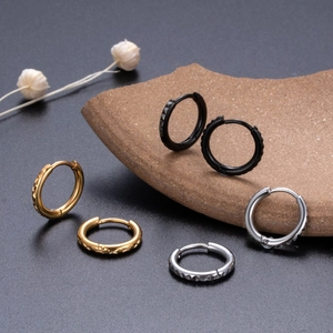 Diamond-cut pattern on gold, silver, and black stainless steel hoop earrings