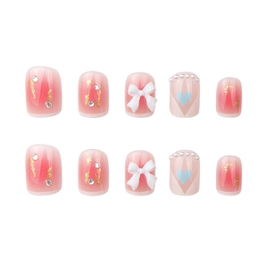 Short press-on nails with pink gradient, white 3D bows, pearls and rhinestone accents