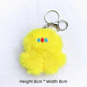 Detail showing 8x8cm plush yellow chicken doll keychain with silver metal clip