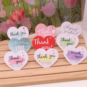 Colorful heart-shaped thank you tags for small business on a wooden display