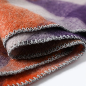 Close-up of cashmere-like scarf showing colorful block texture and gray stitched edges