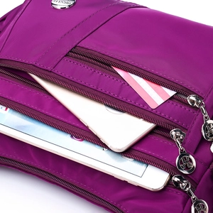 Purple waterproof nylon crossbody bag with multiple zipper pockets for daily storage