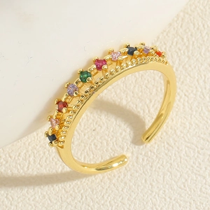 Macro shot of double-layer gold ring with colorful zircon stones in rainbow palette
