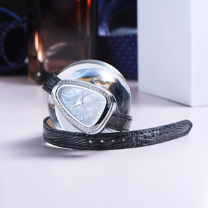 Detail of silver snake head watch with rhinestones and black crocodile leather strap