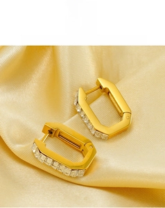 Close-up of 18K gold-plated earrings featuring rectangular zircon inlay and clip closure
