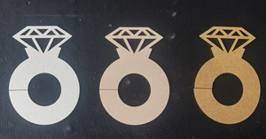 Detail of hollow diamond ring paper placeholders in silver, gold, and champagne colors