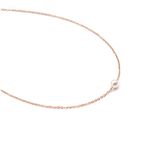 Detailed close-up of an 18K rose gold plated titanium necklace with a white pearl pendant