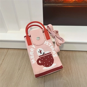 Detail of pink knitted Christmas mini bag with snowman pattern and red round handle