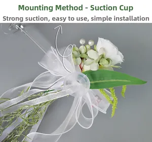 Wedding glass decoration detail showing white rose with green leaf and suction cup base