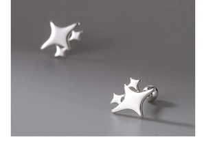 Macro shot of silver star stud earrings with a minimalist geometric design