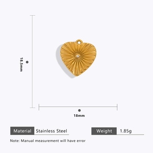 Detailed view of 18k gold plated heart pendant with sunburst texture and tiny diamond